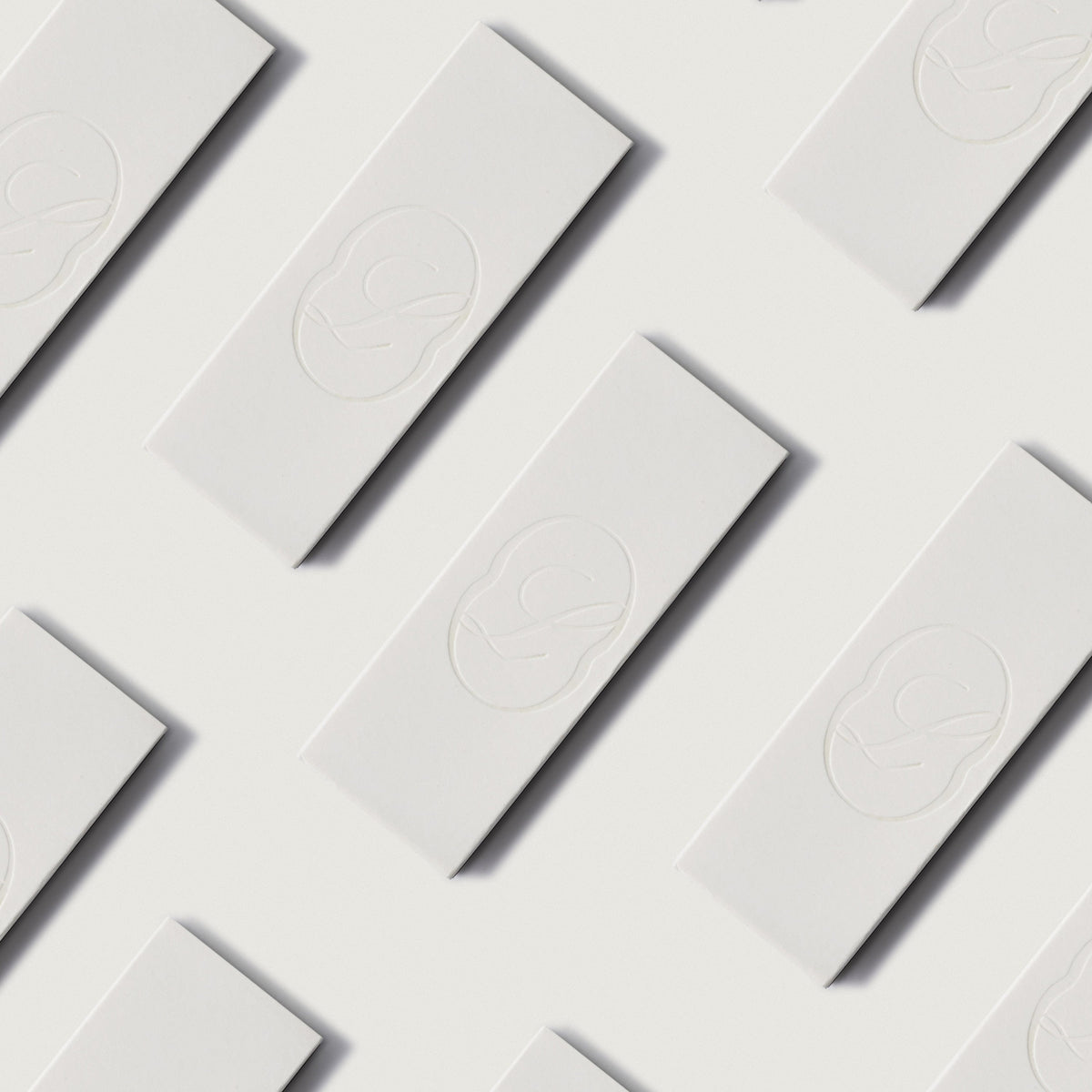 LLIOR matchboxes with embossed monogram arranged in a repeating diagonal pattern