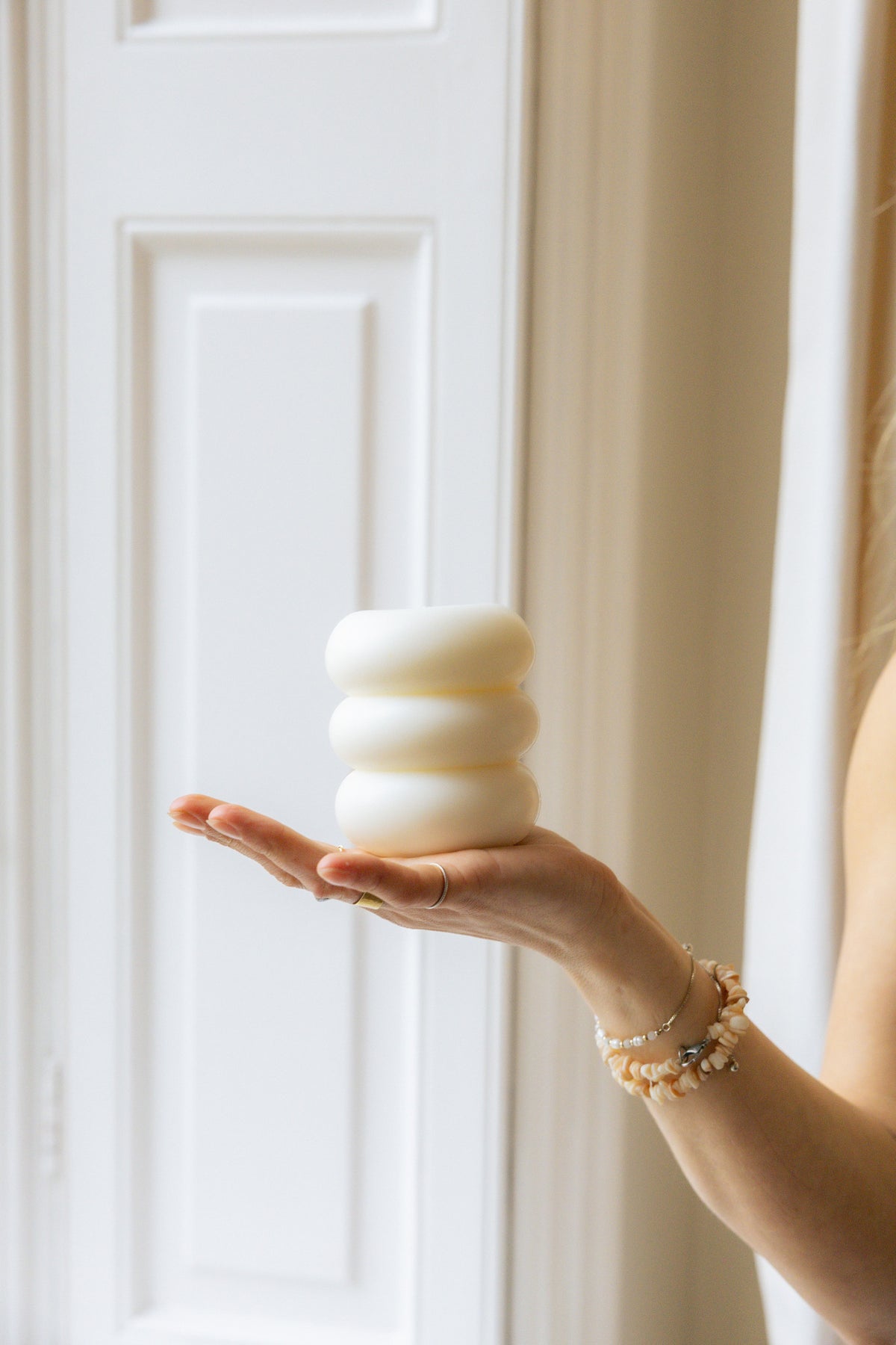 Pillar Candle I resting in an open palm, showing its size