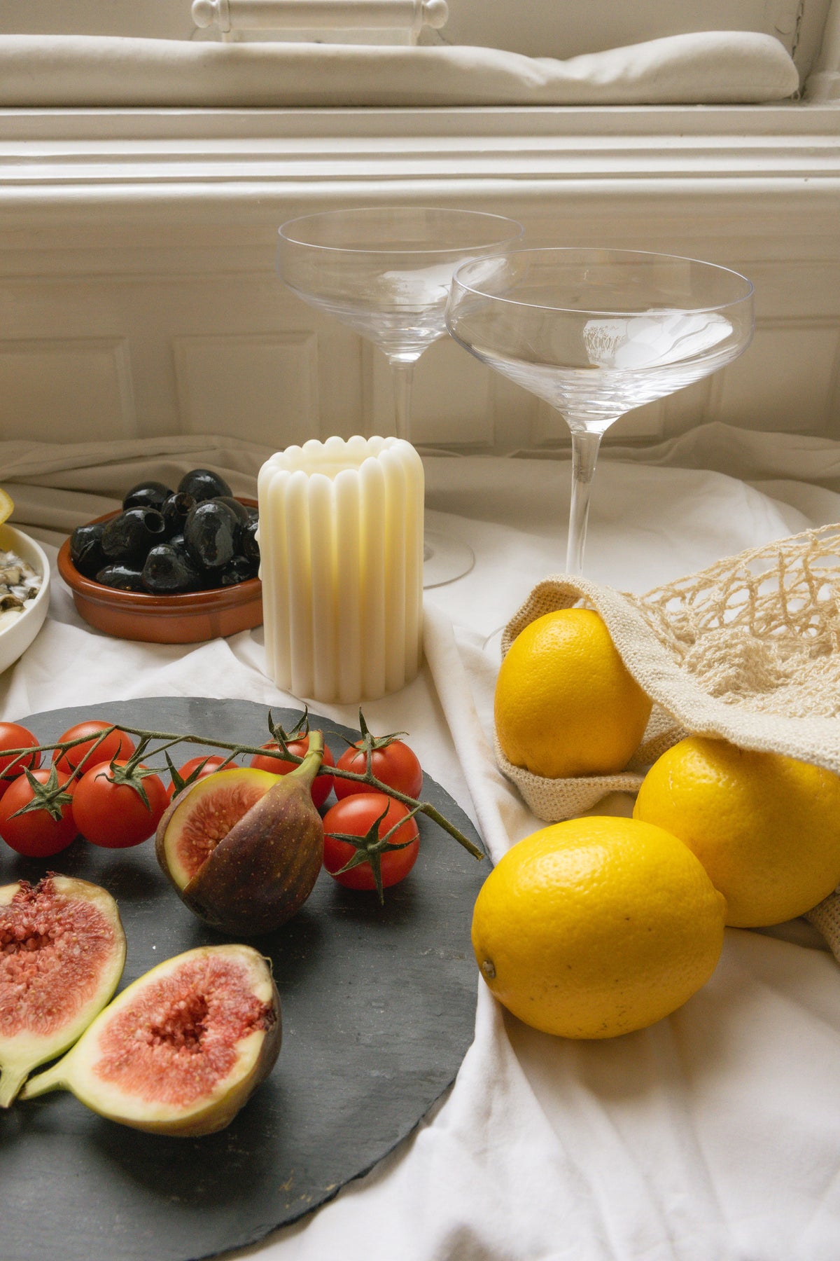 Pillar Candle II on a summer table with lemons, olives and figs