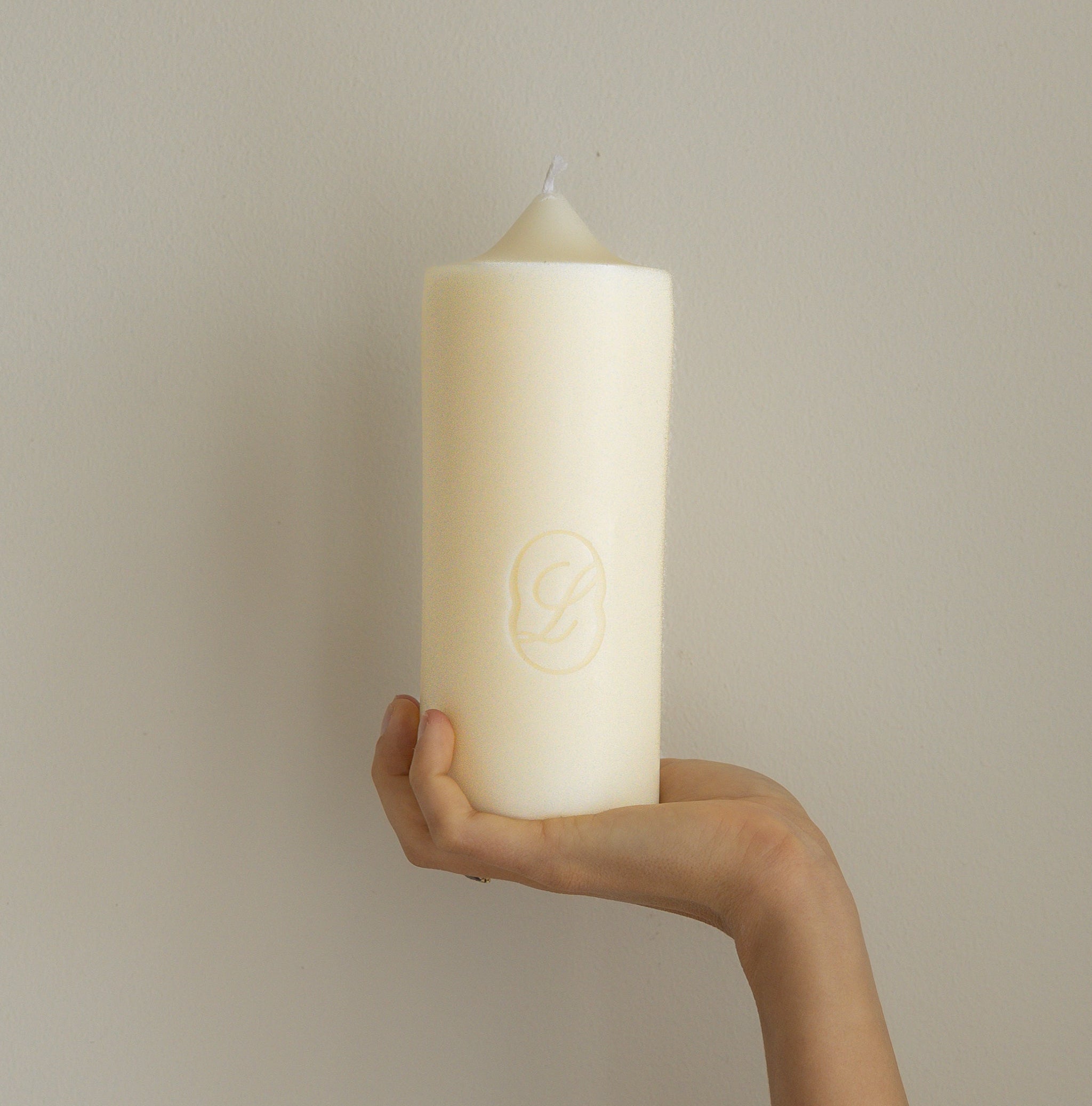 Hand holding LLIOR Signature Candle beeswax soy natural wax premium design object