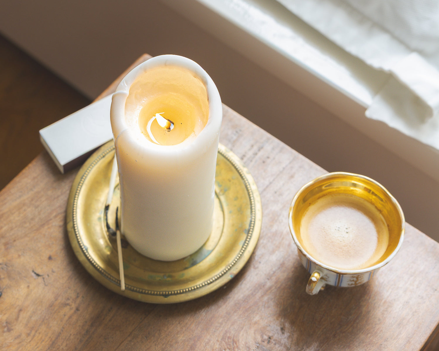 LLIOR Signature Candle lit on brass tray quiet moment