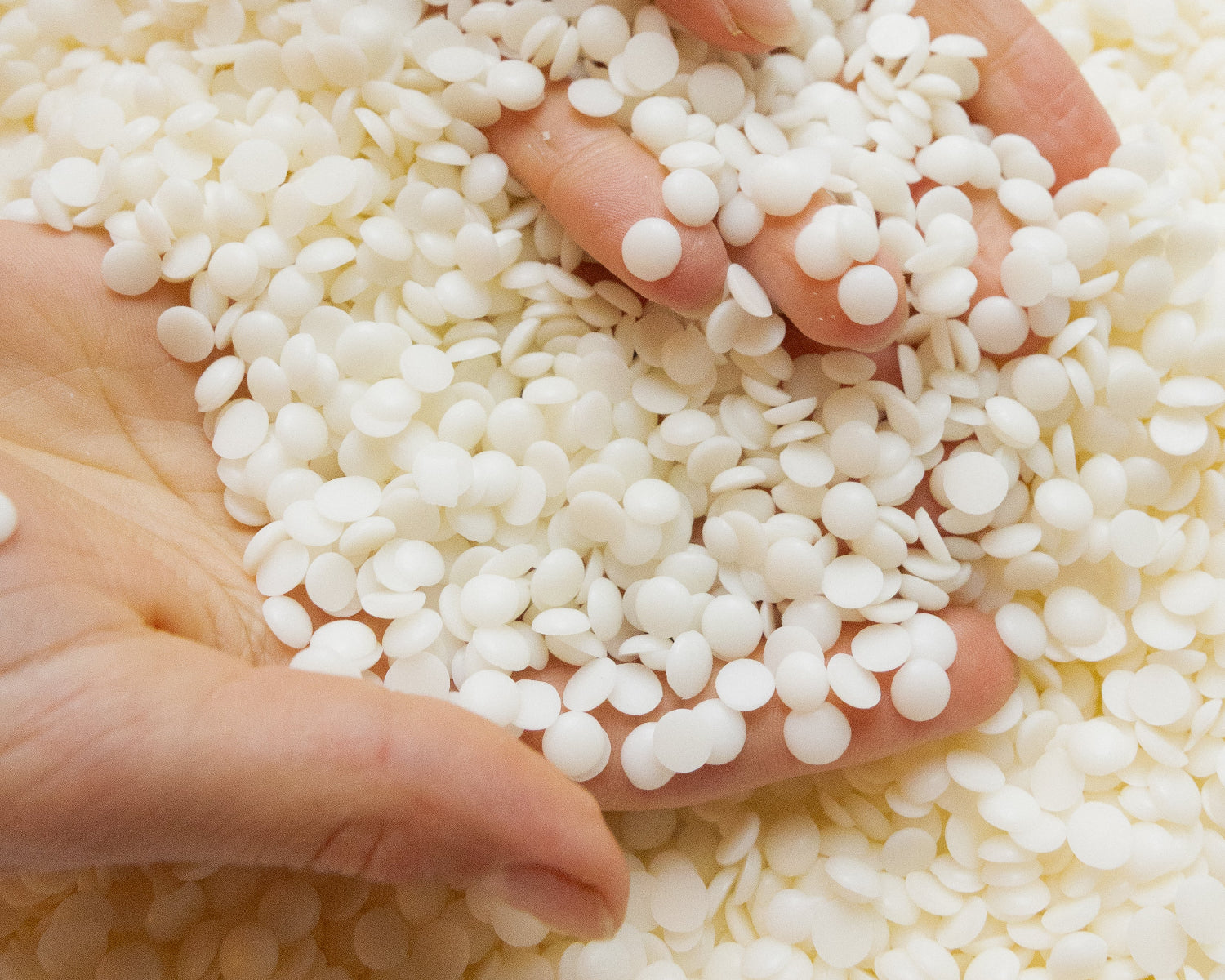 Beeswax soy wax pellets in hand LLIOR natural wax paraffin free Netherlands