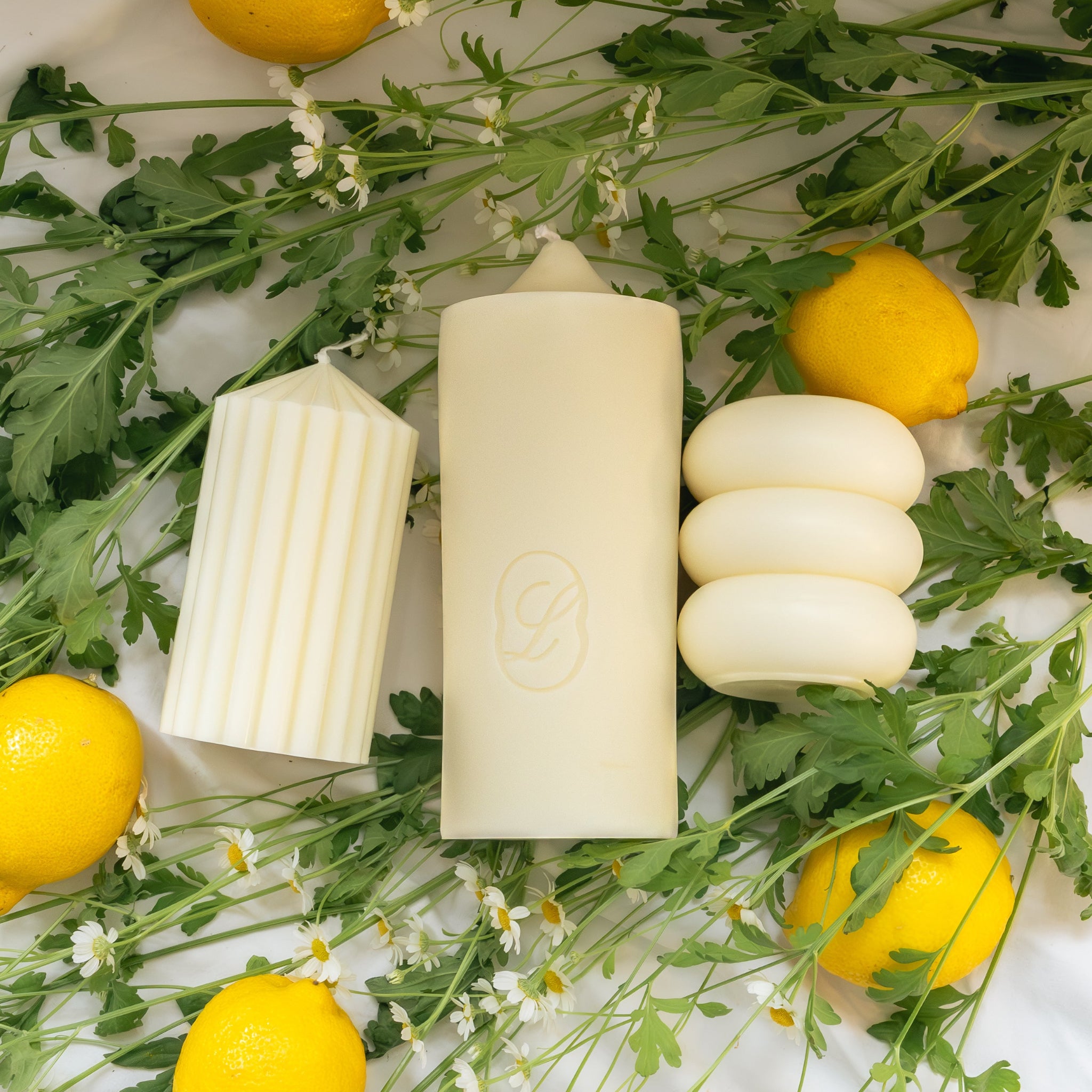 LLIOR Edition No 01 Summer sculptural pillar candles flatlay with lemons and flowers