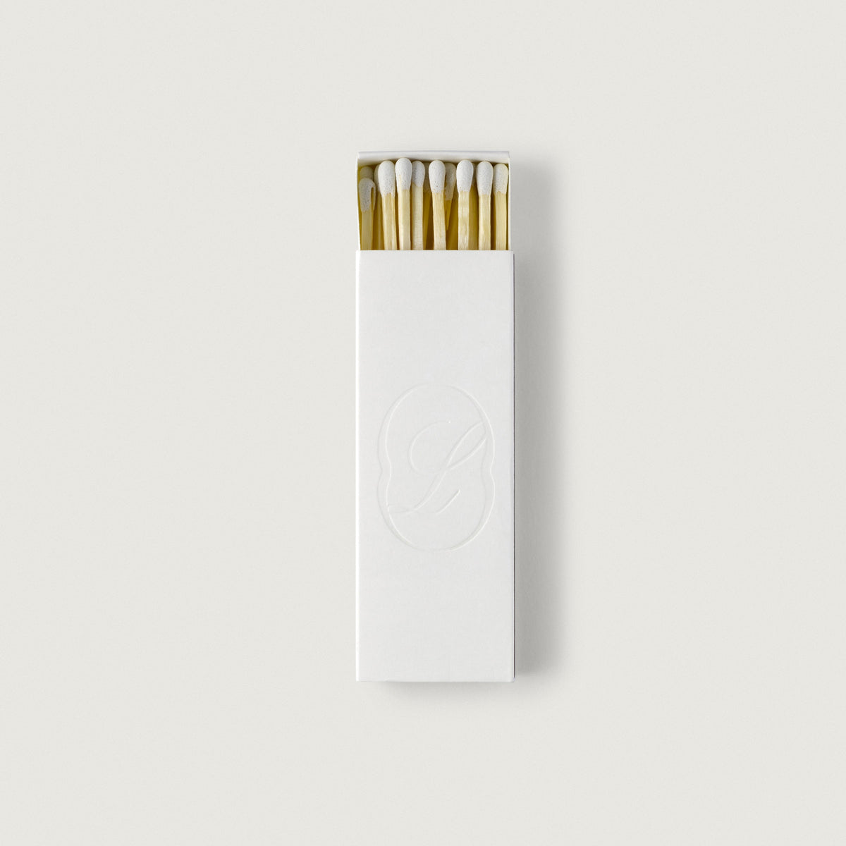 LLIOR matchbox with embossed monogram, opened to show the matches