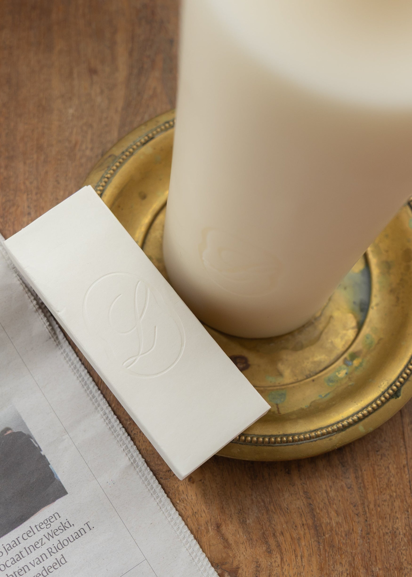 LLIOR matchbox and Signature Candle on brass tray seasonal edition