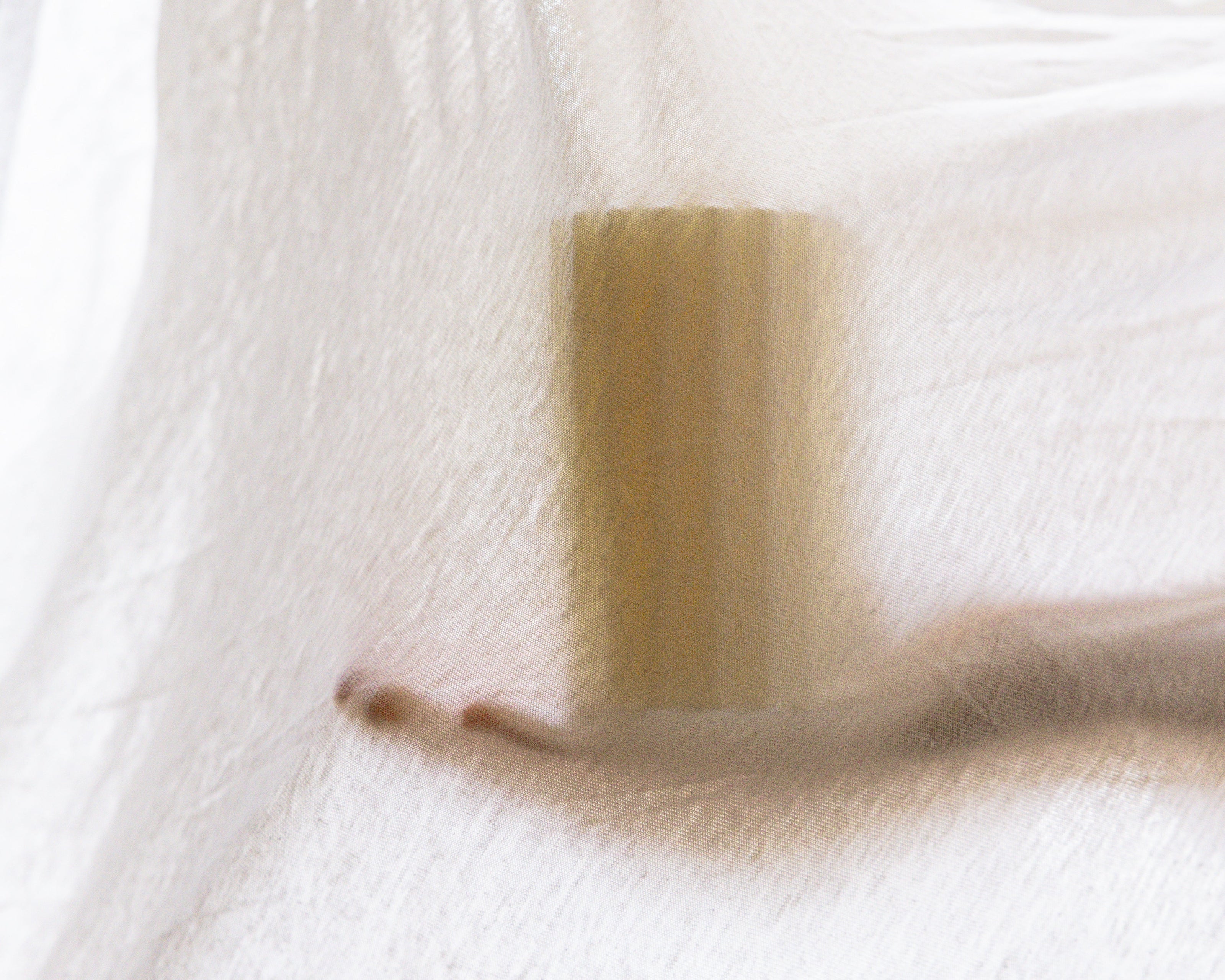 Unscented candle on linen light as interior design LLIOR