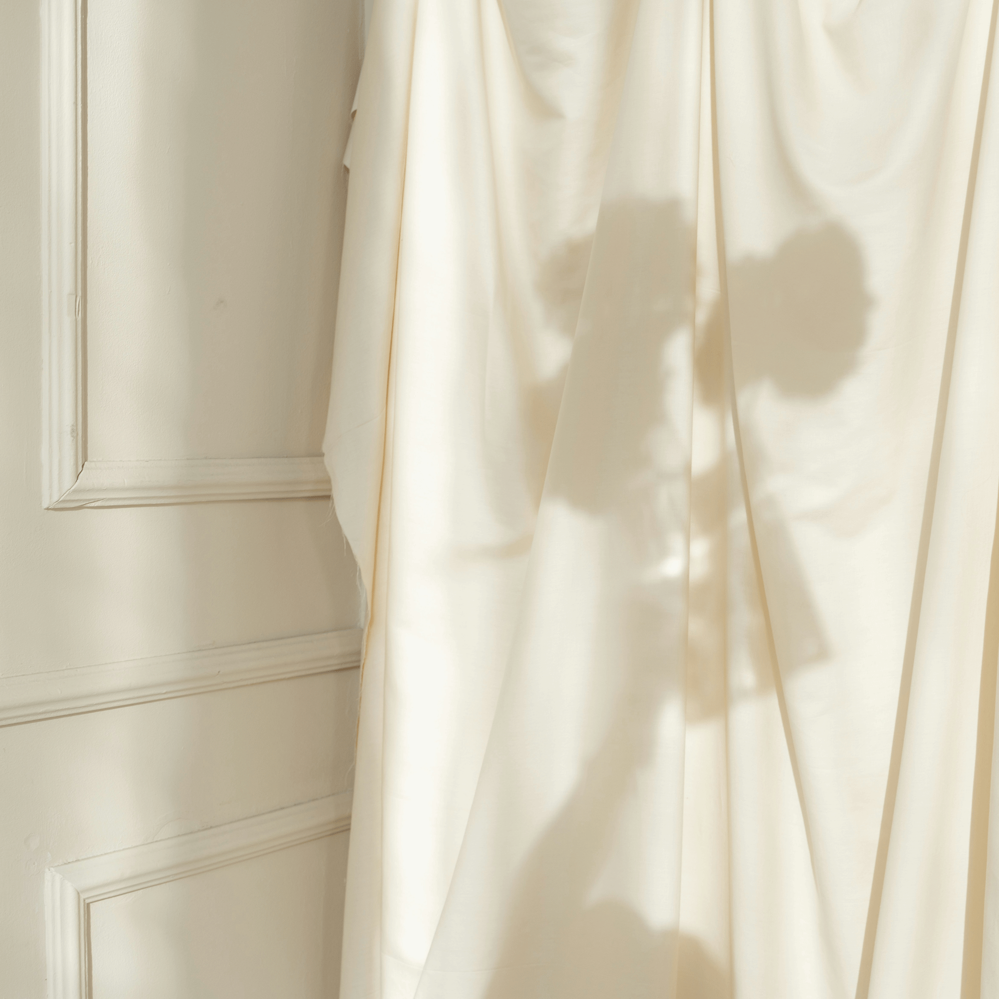 Warm light through satin curtain soft shadow LLIOR